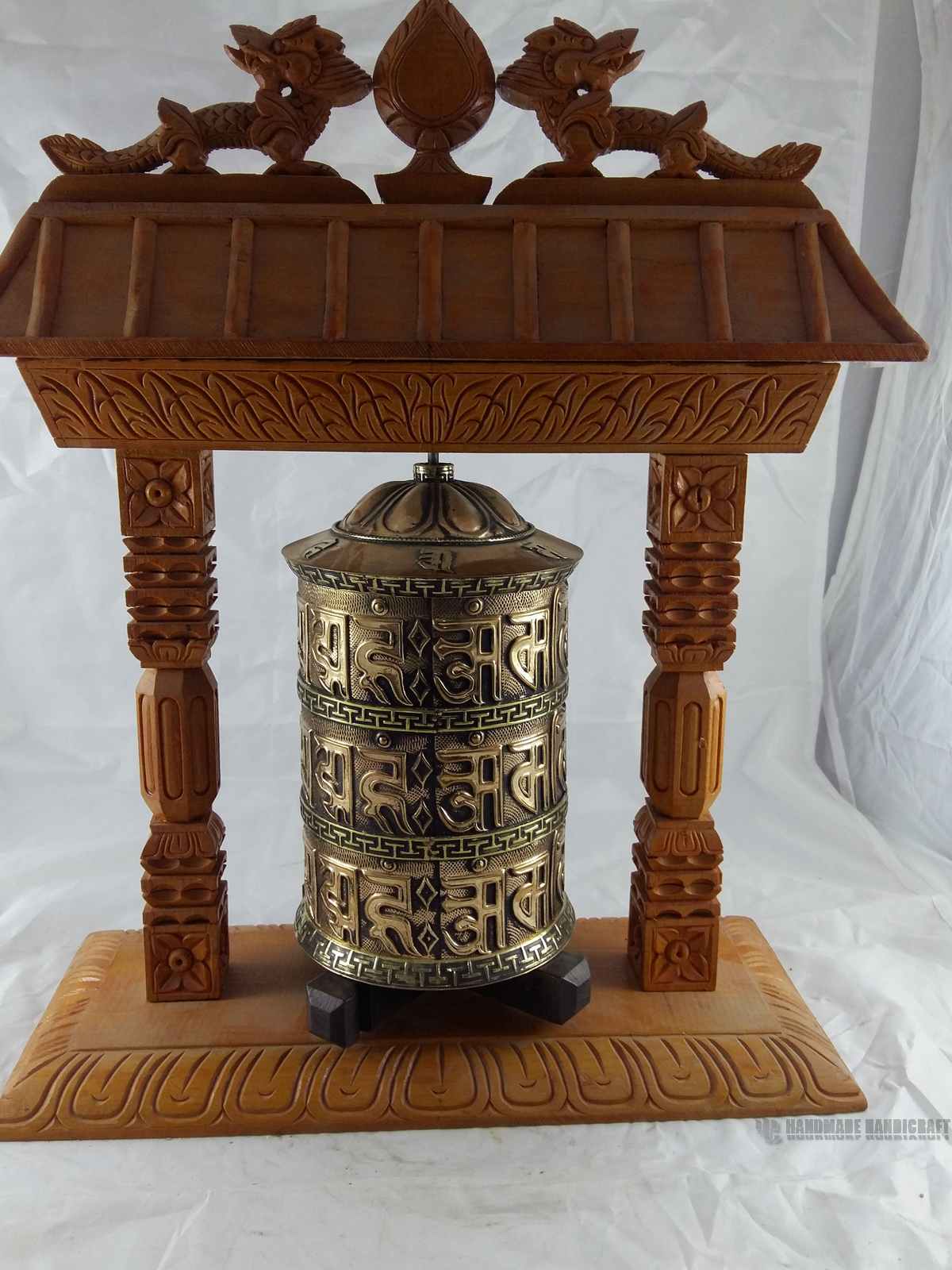 Brass Prayer Wheel On Wooden Temple Frame